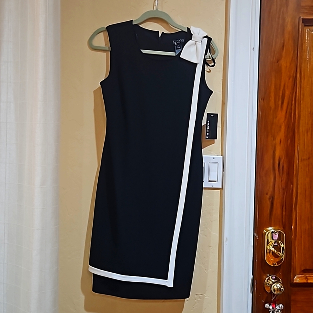 Black dress with a cream color bow on the left side